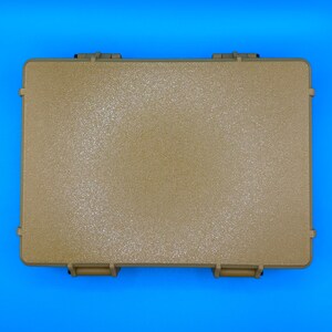 May include: A rectangular, tan-colored hard-shell protective case with a textured surface. The case features two prominent locking latches on the bottom edge and reinforced corners, providing a secure and durable storage solution.