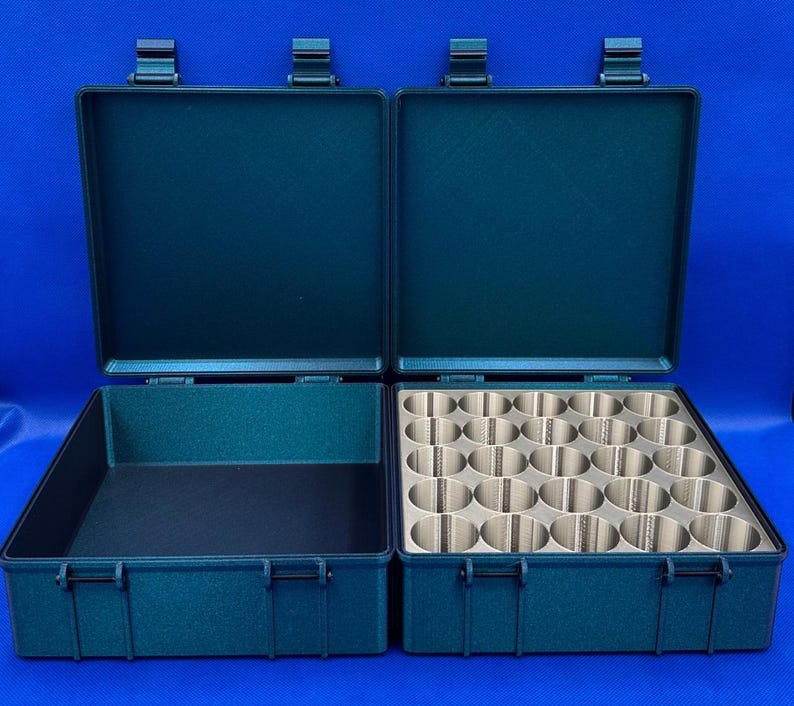 May include: A dark green carrying case with two compartments. One compartment has a foam insert with 24 round holes. The other compartment is empty.