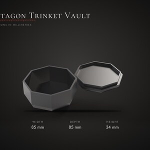 May include: A dark gray octagon trinket vault with a removable lid. The text Octagon Trinket Vault is displayed at the top. Dimensions are listed as 85 mm width, 85 mm depth, and 34 mm height. The object has a geometric, eight-sided shape.