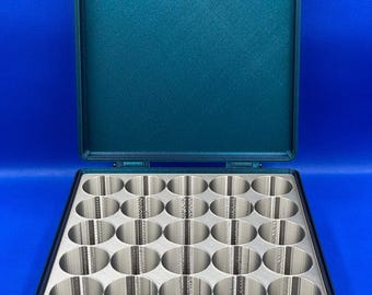 May include: A dark teal plastic storage case with a hinged lid. The case has 24 circular compartments for storing small items.