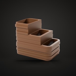 May include: A matte brown tiered organizer featuring three rectangular compartments arranged in a stepped formation. The structure has rounded corners and a smooth, solid finish, designed with a cascading layout that creates three distinct levels.