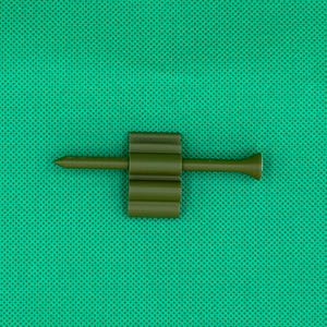 May include: A green plastic golf tee with a pointed end and a ribbed body.