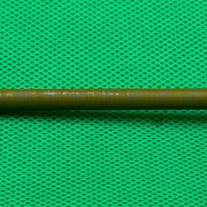 May include: A long, thin, brown metal nail with a pointed tip and a flared head.