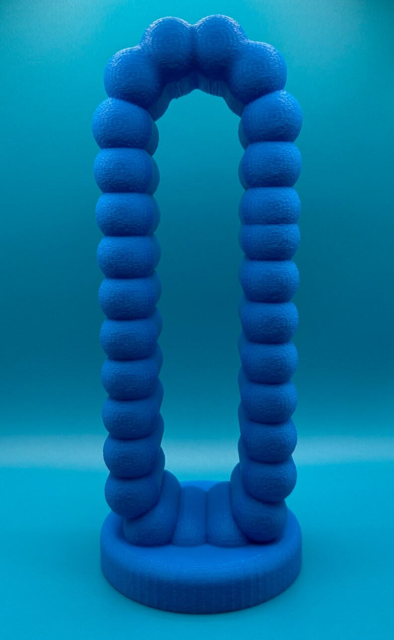 May include: A blue 3D printed sculpture shaped like an archway. The archway is made up of a series of connected spheres.