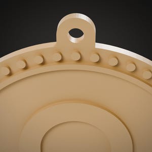 May include: A light tan circular pendant featuring a top loop for hanging. The outer edge is decorated with a series of small, evenly spaced raised circular studs. The center of the pendant has a smooth, recessed circular design.