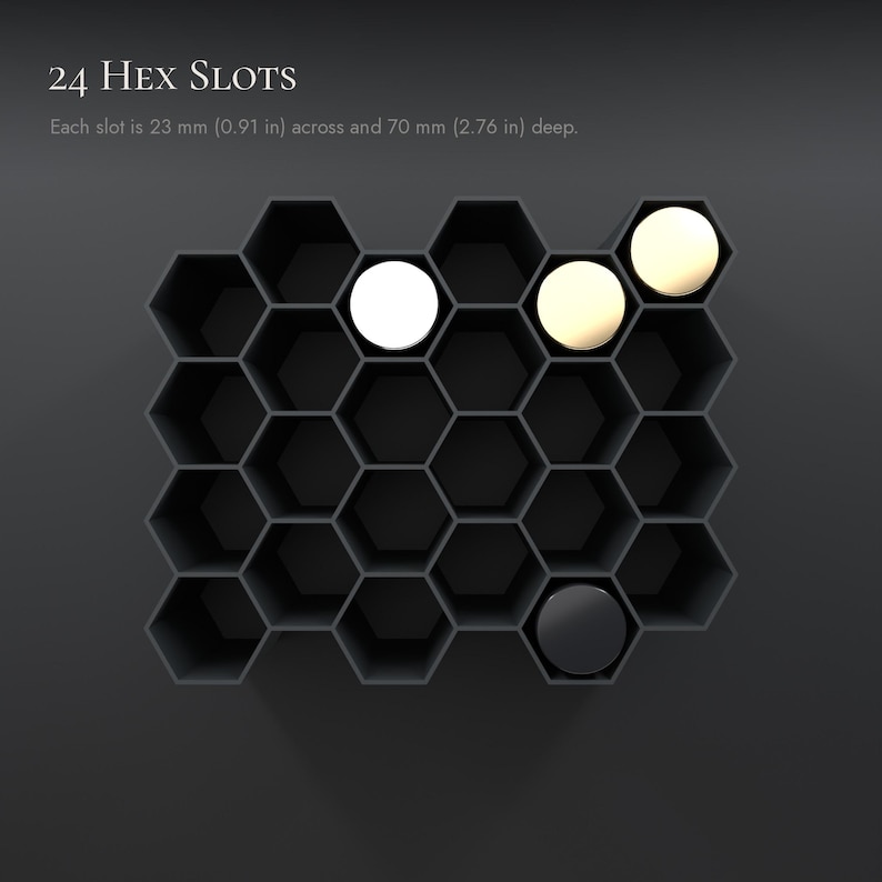 May include: A black honeycomb-style organizer with 24 hex slots. Each slot measures 23 mm (0.91 in) across and 70 mm (2.76 in) deep. The unit features four circular inserts in white, cream, and black colors placed within the hexagonal openings.