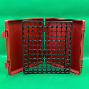 May include: A red plastic storage case with a black grid insert. The case is open and the grid insert is visible. The grid insert has many circular holes.
