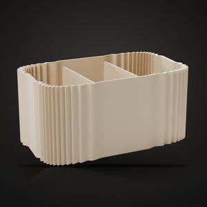 May include: A beige rectangular desk organizer featuring a ribbed, pleated exterior texture. The interior is divided into three distinct sections by two vertical partitions, creating separate compartments for storage and organization.