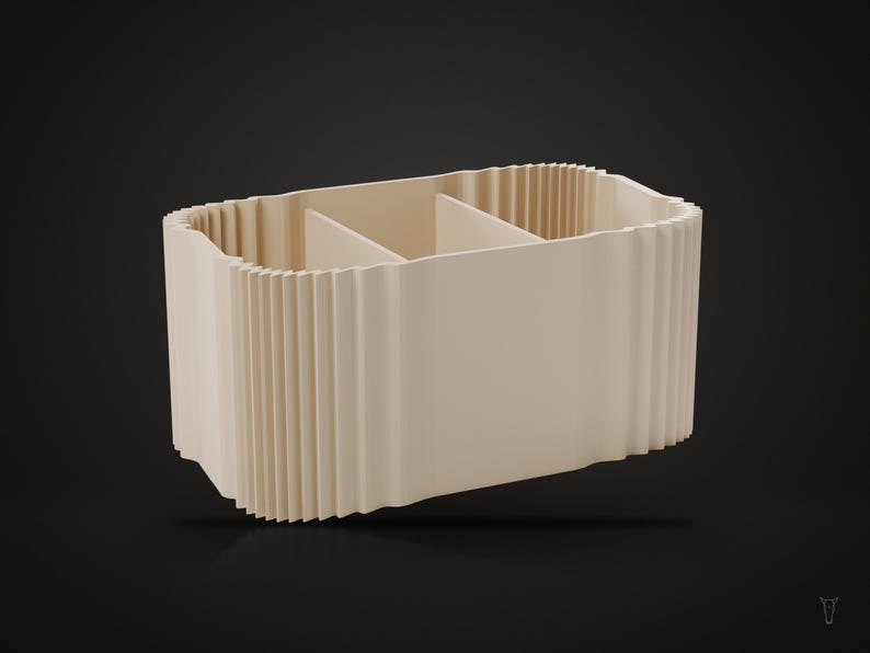 May include: A beige rectangular desk organizer featuring a ribbed, pleated exterior texture. The interior is divided into three distinct sections by two vertical partitions, creating separate compartments for storage and organization.