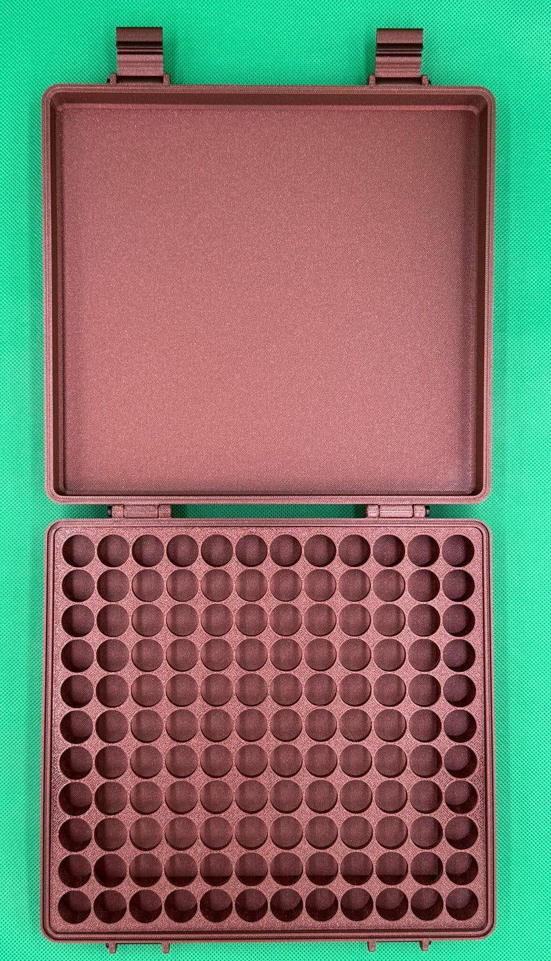 May include: A brown plastic storage case with a hinged lid and a grid of 100 round compartments. The case is open and the compartments are empty.
