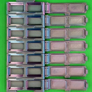 May include: A set of six iridescent, 3D-printed rectangular storage containers with hinged lids. Each container features two recessed compartments with a textured finish, displaying a color-shifting gradient of purple, blue, and metallic silver tones.