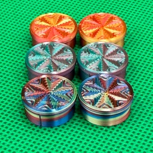 May include: Six round, colorful, decorative, metal,  lids with a starburst pattern. The lids are in shades of orange, blue, and green.