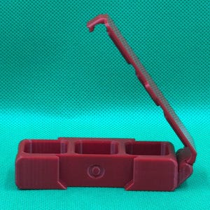 Puede incluir: Una caja de pl&aacute;stico roja con bisagras y tres compartimentos. La caja est&aacute; abierta y la tapa est&aacute; articulada en el lado derecho.