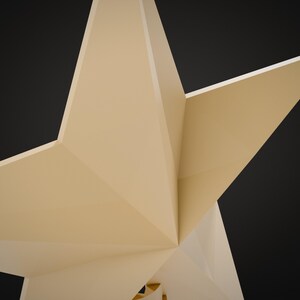 May include: A three-dimensional geometric star sculpture with sharp, angular facets and a smooth, light beige matte finish. The object features multiple pointed rays extending from a central core, creating a complex, multi-faceted structure.