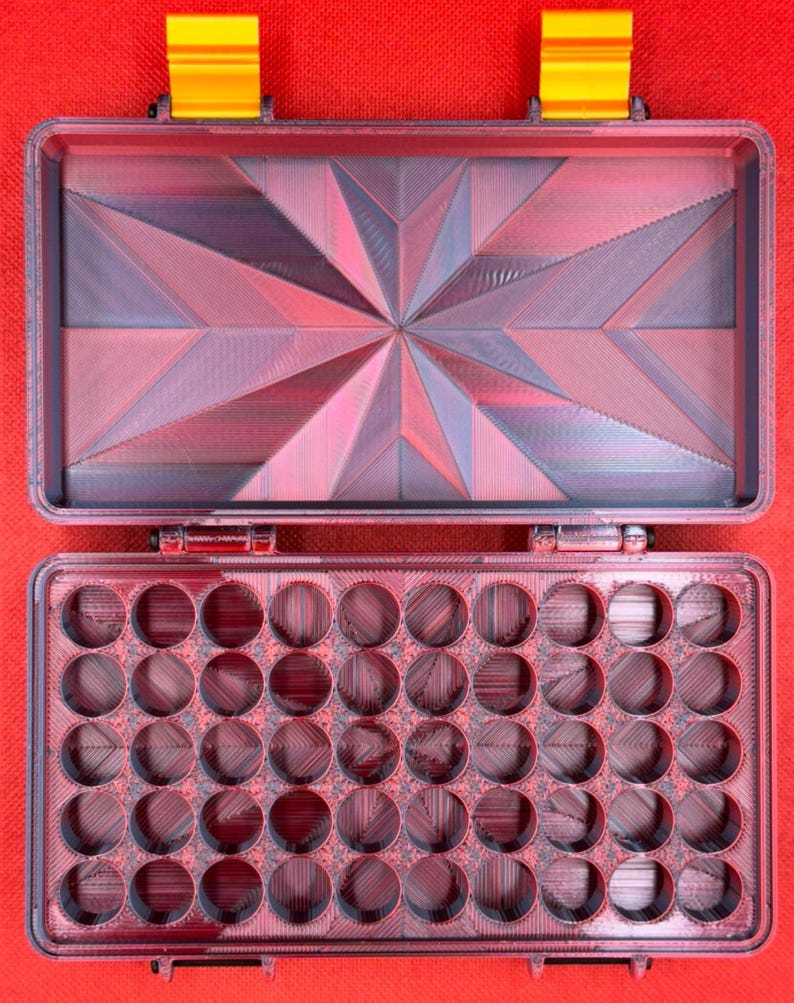 May include: A red plastic storage case with a geometric pattern on the lid and 36 round compartments in the bottom.