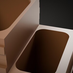 May include: A set of three tiered, rectangular, light beige containers with rounded interior corners. The containers are arranged in a stepped formation, each featuring a deep, hollowed-out center with a smooth, matte finish.