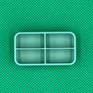 May include: A light teal rectangular silicone mold with four equally sized compartments, perfect for crafting. The mold has rounded corners and is set against a textured green background. Ideal for creating small, uniform shapes.