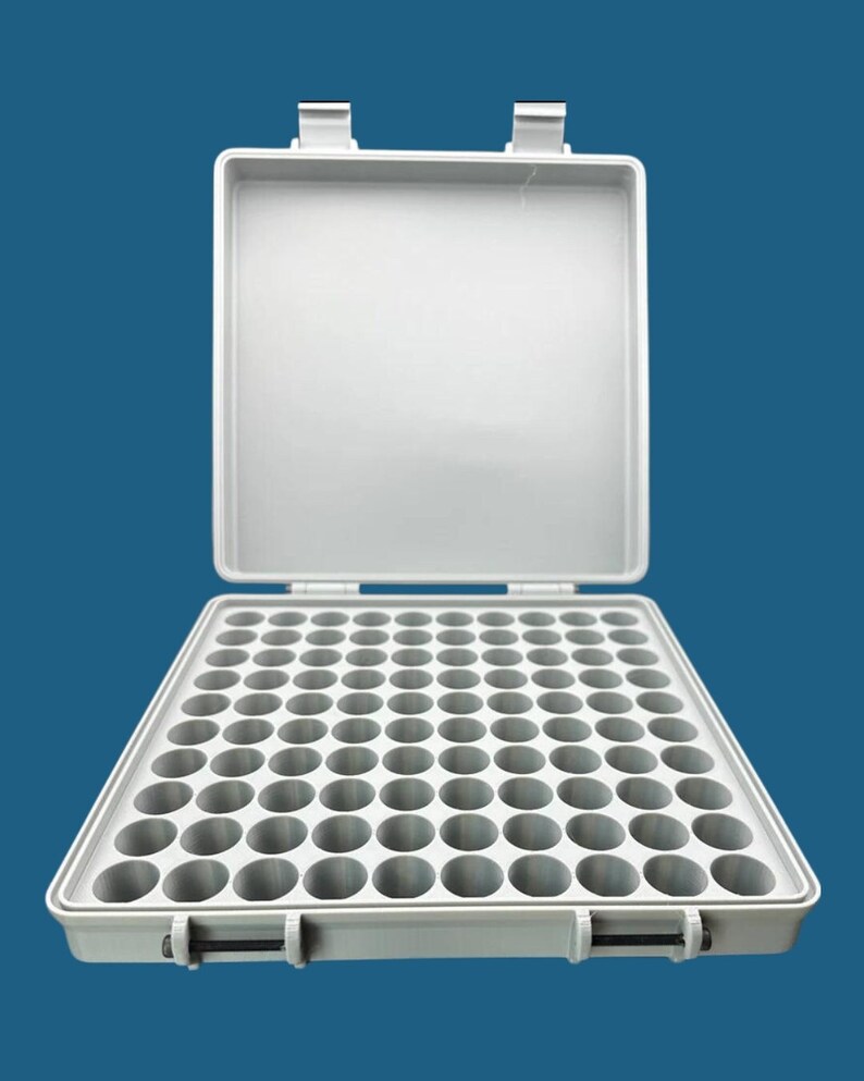 May include: A light gray rectangular storage case with an open hinged lid. The interior base features a grid of one hundred circular compartments arranged in ten rows and ten columns, designed for organizing small items in a structured way.