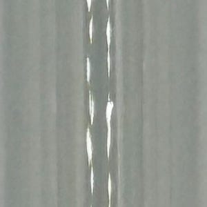 May include: A clear glass vial with a silver metal crimp cap and a dark, iridescent circular topper positioned above it. The vial features a cylindrical body and a black rubber stopper visible at the base, creating a distinct contrast.