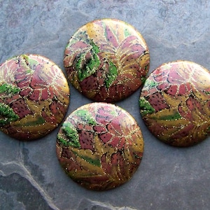 May include: Four round, decorative, gold, pink, and green floral patterned buttons.