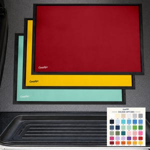 May include: Three rectangular floor mats with black borders, stacked in red, yellow, and mint green. Each mat features the white CamperStyle logo in the bottom left corner. A small square colour chart displays thirty-five different colour options.