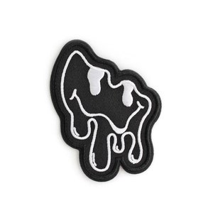 May include: Black embroidered patch with a white dripping smiley face design.