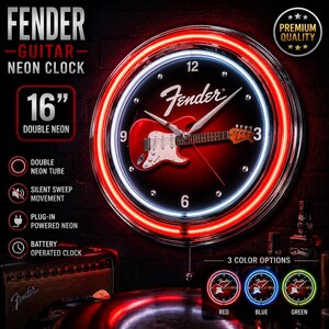 May include: A 40 cm Fender guitar neon clock with a double neon tube and silent sweep movement. The clock features a red guitar graphic on a black background, surrounded by a red and white neon ring. It has plug-in powered neon and battery operation.