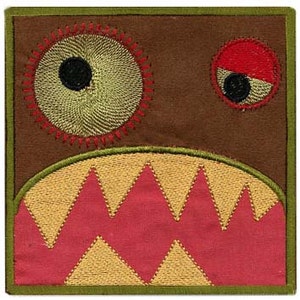 May include: Embroidered patch with a brown background, a large green eye with a black pupil, a smaller red eye with a black pupil, and a pink and yellow jagged mouth.