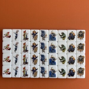 May include: A set of white tiles featuring colorful cartoon characters. The tiles are arranged in rows and columns, with various animal characters in different poses. The background is a solid orange color.