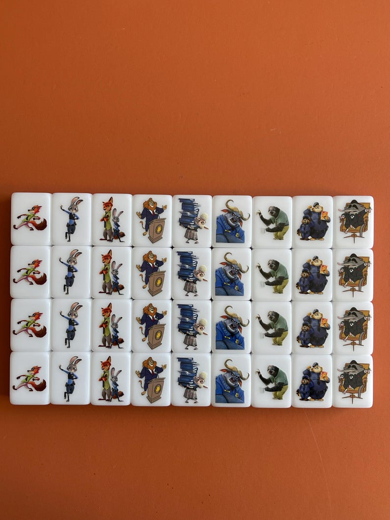 May include: A set of white tiles featuring colorful cartoon characters. The tiles are arranged in rows and columns, with various animal characters in different poses. The background is a solid orange color.