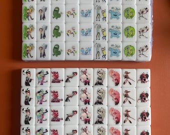 May include: Two sets of white dominoes with cartoon images. The first set features characters from the animated series Rick and Morty. The second set features characters from the animated series Helluva Boss.