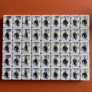 May include: A set of 40 white square tiles with images of people in black clothing. Each tile features a different person with a unique pose and expression.