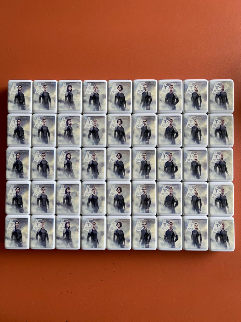 May include: A set of 40 white square tiles with images of people in black clothing. Each tile features a different person with a unique pose and expression.