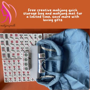 May include: A complete mahjong set with white tiles featuring red, green, and black symbols and characters. The set includes a blue storage bag and a white case. The text on the image says "Free creative mahjong quick storage bag and mahjong mat for a limited time, save more with loving gifts."
