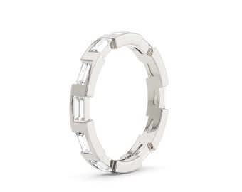 May include: A silver band ring with a row of baguette-cut diamonds set in a channel setting.