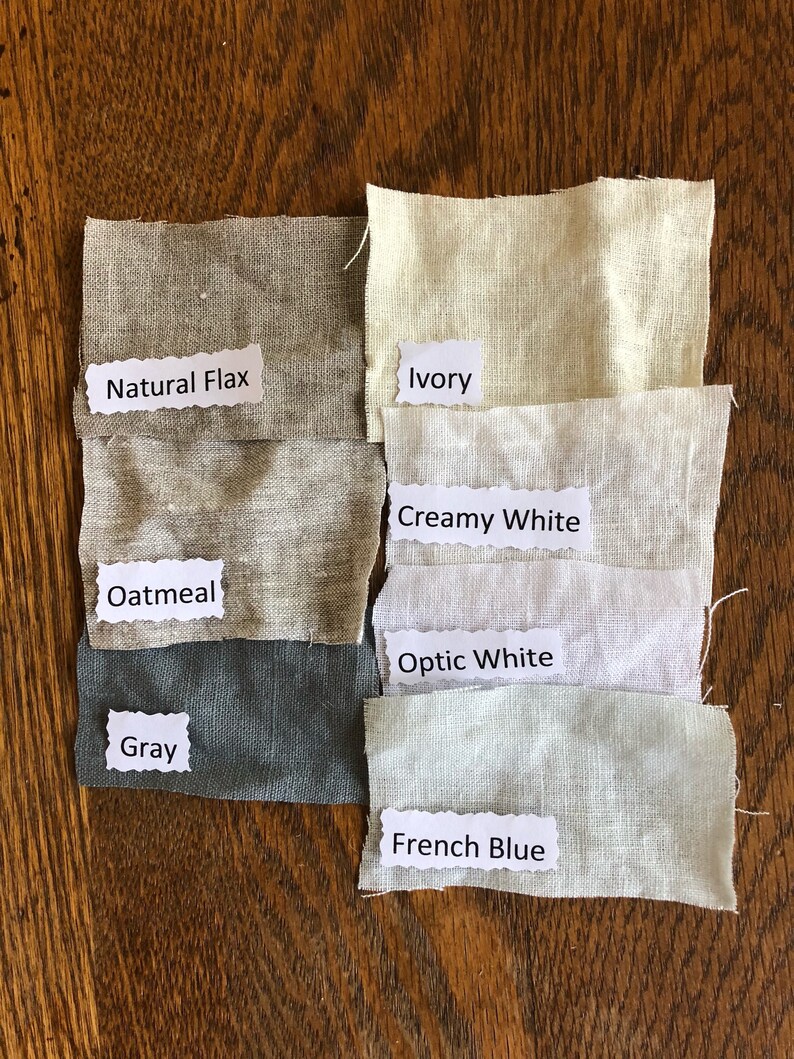 May include: Six fabric swatches in different shades of white, gray, and blue. The swatches are labeled with the following names: Natural Flax, Ivory, Creamy White, Optic White, Gray, and French Blue.