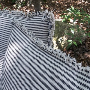 Ticking pillows with frayed edges 
Custom made