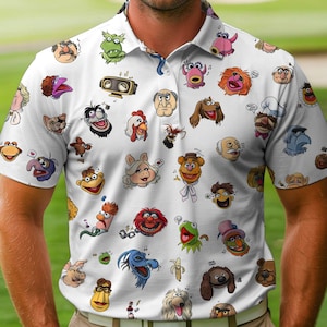 May include: White polo shirt featuring a repeating pattern of colorful Muppet characters. The short-sleeved shirt has a collared neckline and is made of a lightweight fabric, suitable for casual wear or themed events.