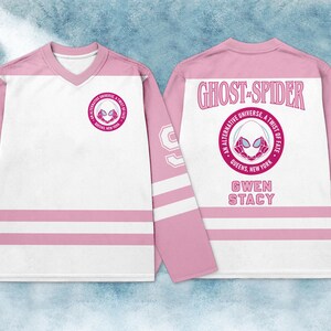 May include: A pink and white hockey jersey featuring the Ghost-Spider logo on the front and back. The back of the jersey displays the words "GHOST-SPIDER" and "GWEN STACY". The sleeves have white stripes and the number 99.