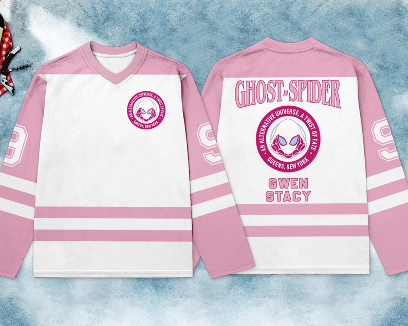 May include: A pink and white hockey jersey featuring the Ghost-Spider logo on the front and back. The back of the jersey displays the words "GHOST-SPIDER" and "GWEN STACY". The sleeves have white stripes and the number 99.