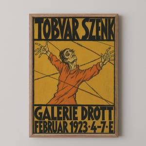 May include: A framed poster featuring a mustard yellow background with black text reading TOBVAR SZENK at the top and GALERIE DROTT FEBRUAR 1923 4-7 E at the bottom. A central illustration depicts a person in an orange shirt with arms raised.