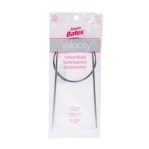May include: A pair of silver Susan Bates Velocity circular knitting needles in a plastic package. The needles are 3.5 mm (US size 4) and 29 inches long. The package also includes the text "Premium Quality, Qualité Supérieure, Calidad Premium".