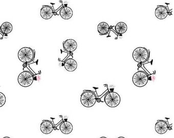 May include: A seamless pattern featuring black and white bicycles with baskets on a white background.