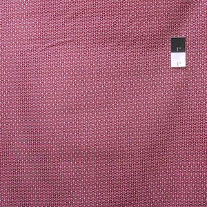 May include: Close-up of a fabric with a repeating pattern of white dots on a deep red background. The pattern is a series of small, interconnected shapes. A ruler with 1-inch markings is in the upper right corner. The fabric appears to be cotton or a similar material.