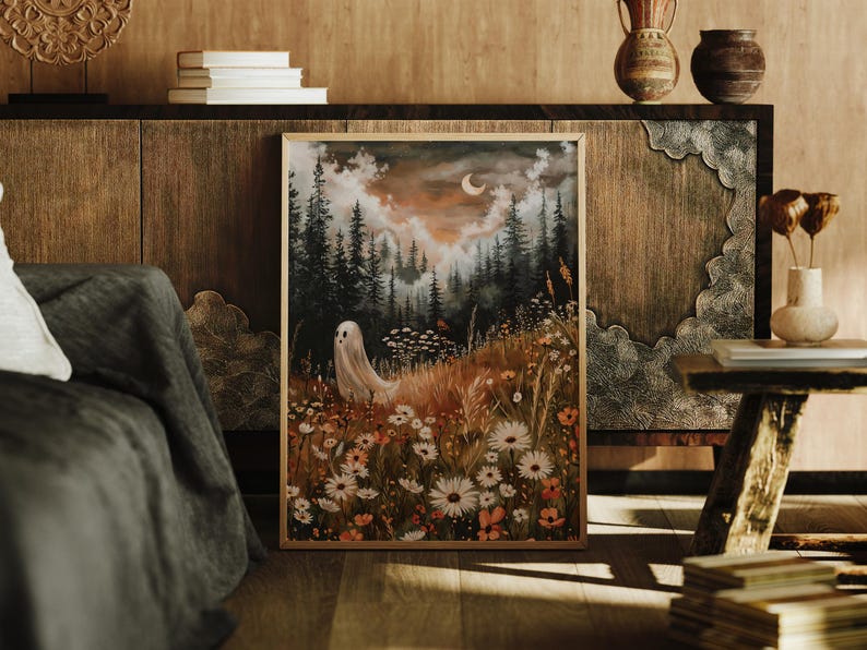 May include: A framed illustration of a white ghost standing in a field of wildflowers. The background is a dark forest with a crescent moon in the sky.