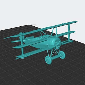 May include: A teal-colored model airplane with three wings, two wheels, and a propeller. The model is a replica of a vintage aircraft, with detailed struts and a rounded fuselage. The plane is set against a dark grid background.