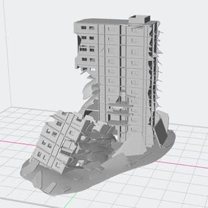 May include: A gray, 3D-printed model of a multi-story building in a state of disrepair. The structure is partially collapsed, with sections of the facade missing, revealing interior details. The model sits on a grid.