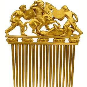 May include: A golden comb featuring a detailed relief of a battle scene with figures on foot and horseback. The comb's teeth are long and parallel. Text at the top reads "SCYTHIAN GOLDEN" and "Digital download STL File".