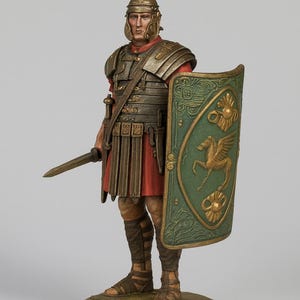 May include: A detailed figurine of a Roman soldier in full armor, holding a sword and shield. The shield is green with a gold winged horse emblem. The soldier wears a red tunic and a crested helmet. The figurine stands on a green base.