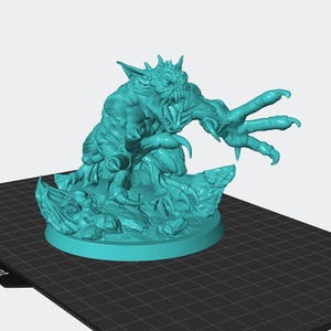 May include: A teal-colored monster figurine with sharp claws, teeth, and horns. The creature is posed on a rocky base, with a round platform. The monster has a menacing expression and is sculpted with detailed musculature.